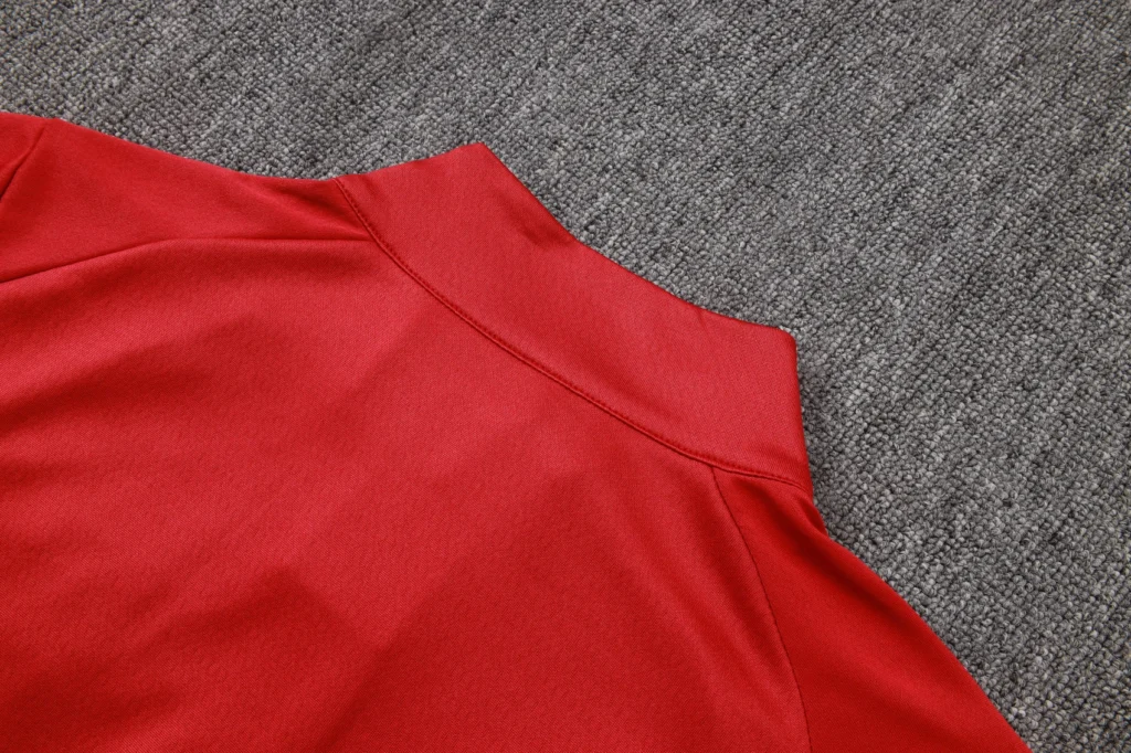 Red long-sleeve soccer training top with athletic panel construction