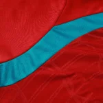 Close-up of breathable textured fabric and teal panel on soccer training top