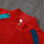 Red soccer training top featuring zip stand collar and textured fabric