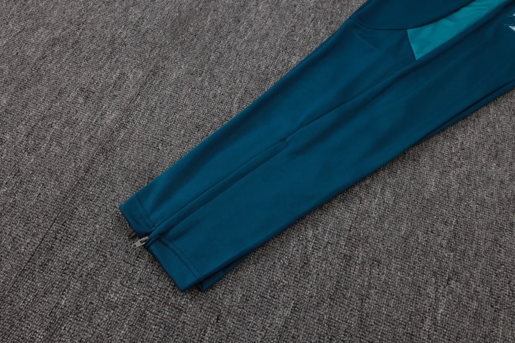 Teal tapered soccer training pants with ankle zipper opening