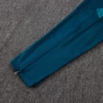 Teal tapered soccer training pants with ankle zipper opening