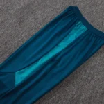 Teal soccer training pants with contrasting textured side panel